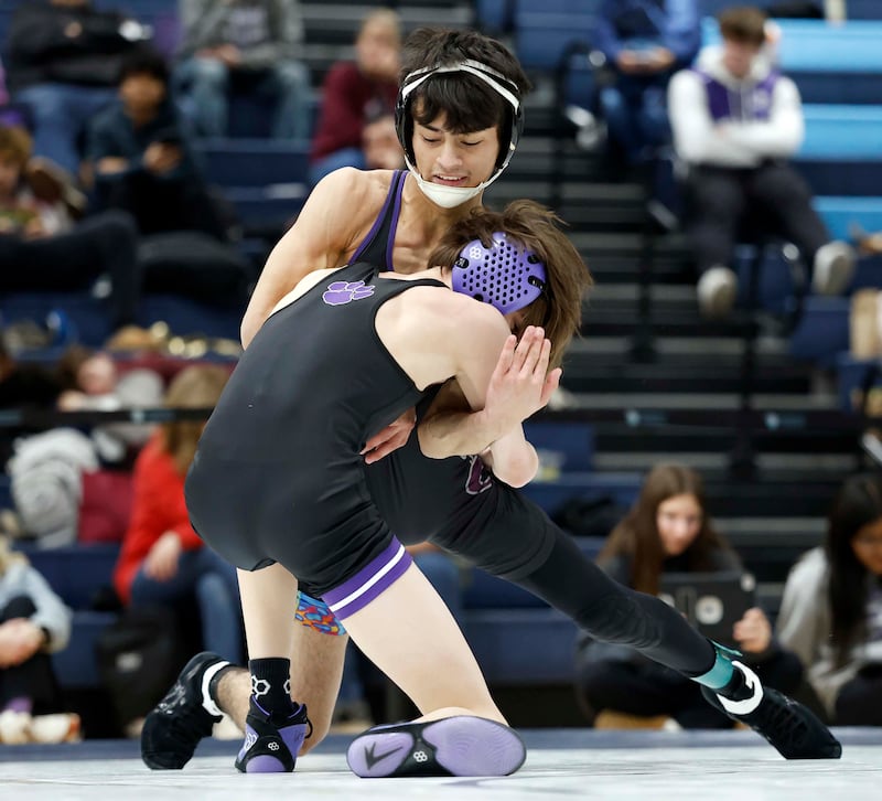 Hampshire’s Luthor Rajcevich wrestles Dixon’s Riley Paredes at 106-pounds during the semi-final round of the 65th Mudge-McMorrow Wrestling Invite Saturday, Dec. 13, 2025 in Mount Prospect.
