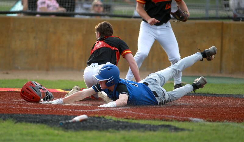 St. Charles North's Chase Ferguson slides safely into home plate during a game against Batavia on Thursday, April 24, 2025 in Batavia.