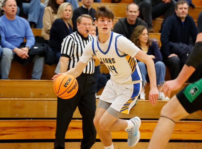 Lyons' Grant Smith (14) handles the ball during a varsity basketball game between York Community and Lyons Township high schools on Friday, Jan. 9, 2026 in La Grange.