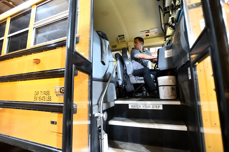 Herscher High School principal Brad Elliot backs out bus from the garage on July 20, 2022, ahead of the upcoming school year. Elliot, along with superintendent Rich Decman, curriculum director Pete Falk and transportation director Michelle Armstrong, acquired their CDL licenses to cover bus routes as driver shortages hit the district. Elliot drove over 100 routes last school year.