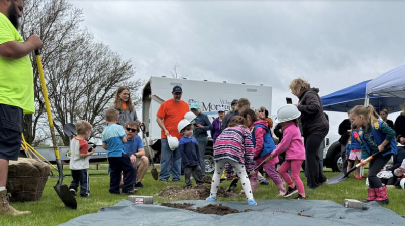 Kids and community members help plant at tree at the Arboretum Garden Park during the village of Montgomery's Arbor Day celebration. This year, the village will be planting a Pawpaw Tree.