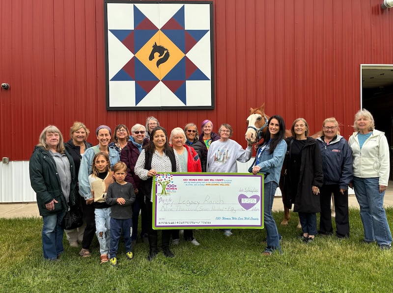 Members of 100+ Women Who Care Will County meet with Executive Director of Legacy Ranch Kate Rasmussen and other ranch staff members to present their "big check" donation.