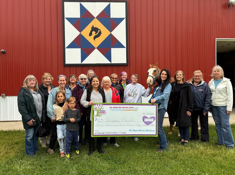 Members of 100+ Women Who Care Will County meet with Executive Director of Legacy Ranch Kate Rasmussen and other ranch staff members to present their "big check" donation.