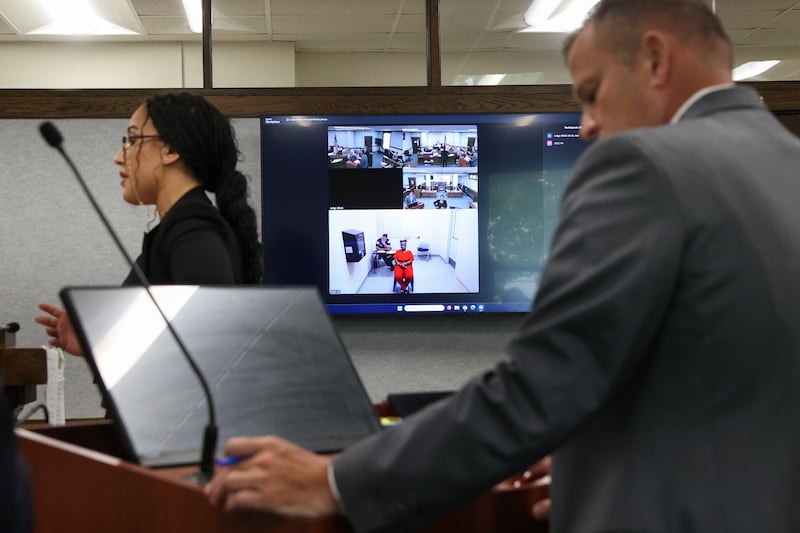 Defendant Xandria Harris appears on screen as Kankakee County State's Attorney Jim Rowe, right, and defensive attorney Cierra Norris, left, address Kankakee County Circuit Judge Kathy Bradshaw-Elliott during court proceedings for Harris on Friday, June 5, 2026