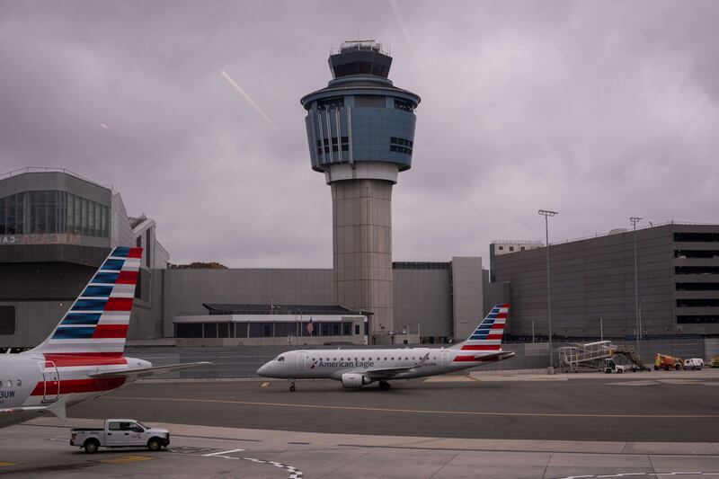 An American Eagle plane moves past the FAA Air Traffic Control tower at LaGuardia Airport (LGA) in the Queens borough of New York, Sunday, Nov. 9, 2025. (AP Photo/Adam Gray)