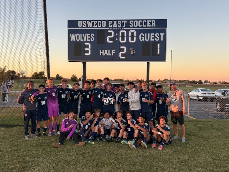 The Oswego East soccer team poses after beating Yorkville 3-1 for the 200th win in program history.
