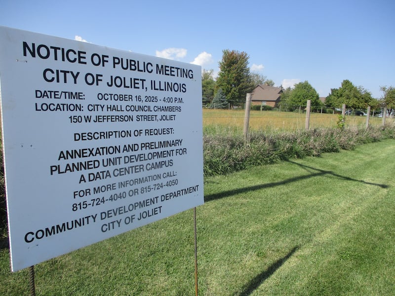 A Ridge Road farmstead is seen in the background of a sign posting notice of plans to develop the land and annex it into Joliet for an electronic data center. Oct. 3, 2025