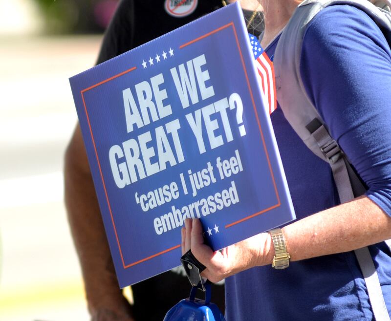 A participant in the "Workers Over Billionaires" rally in downtown Oregon holds her sign in downtown Oregon on Monday, Sept. 1, 2025.