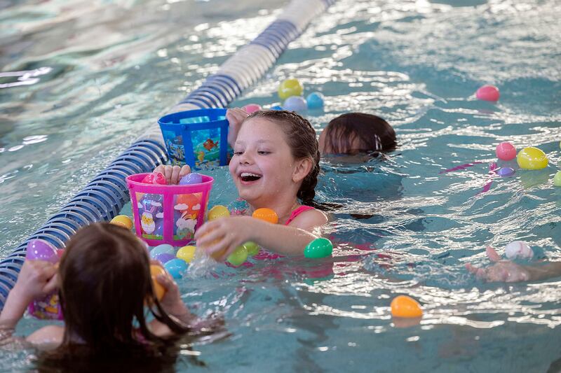 Iris Parks, 9, of Sterling grabs eggs Friday, April 11, 2025, during the Sterling-Rock Falls YMCA Easter Egg Hunt. Kids up to age 9 had a chance to swim around to gather floating eggs for prizes.