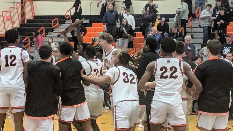 DeKalb players celebrate with the championship plaque after the Barbs' 57-45 win over Hononegah in the Class 4A Harlem Regional title game on Friday.