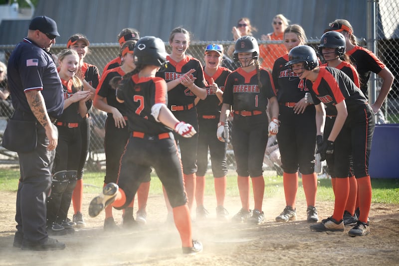The Beecher softball team greets Makenzie Johnson (2) at home plate after her two-run home run in the top of the seventh inning of the Bobcats' 4-0 win at Wilmington Thursday, April 23, 2026.