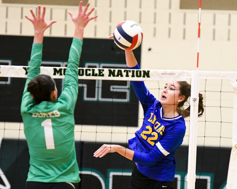 Lyons Township's Emma O'Brien (22) spikes the ball past York's defender Amalia Toliopoulos (1) during the regional title game on Thursday Oct. 30, 2025, held at York High School.