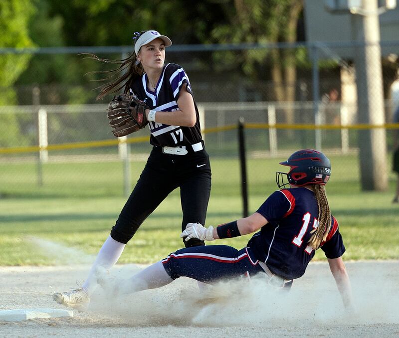 Dixon’s Kiley Gaither looks to throw after an out against Belvidere North’s Paige Johnson Tuesday, May 27, 2025, during a Class 3A Regional softball game in Dixon.