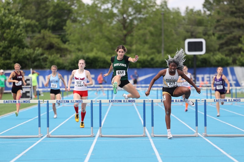 St. Bede’s Lily Bosnich, center, clears the final hurdle just behind Tuscola's Lia Patterson in the 300 m hurdles during the IHSA Class 1A Girls Track & Field State Finals on Saturday, May 24, 2025.