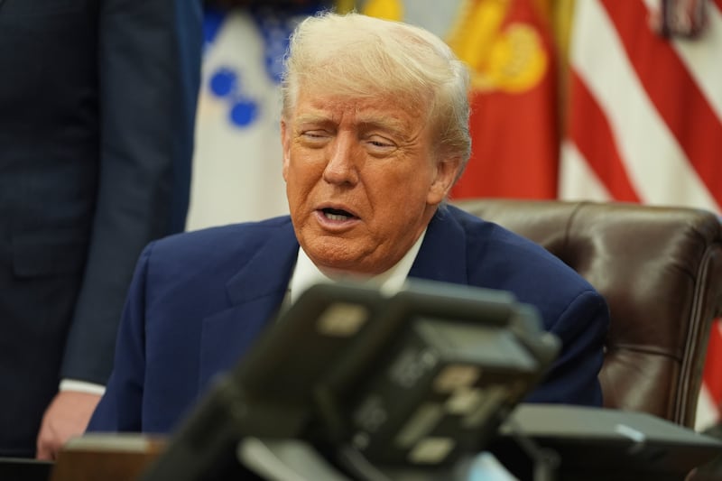President Donald Trump speaks on the phone to Britian's Prime Minister Keir Starmer on a trade deal between the US and United Kingdom in the Oval Office of the White House, Thursday, May 8, 2025, in Washington. (AP Photo/Evan Vucci)