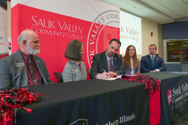 Jon Mandrell of Sauk Valley Community College signs an agreement between SVCC and Northern Illinois University that creates a seamless transfer pathway from SVCC’s associate in applied science in criminal justice to NIU’s bachelor of science in public service leadership.