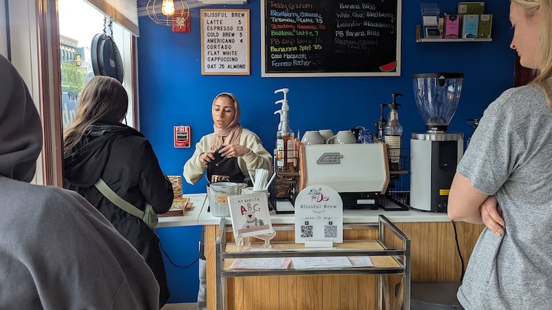 Nour Zein, owner of Blissful Brew Coffee Co. in Lockport, serves customers on Sunday, April 13, 2025.