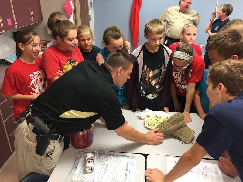 Former School District 303 liaison officer Eric Majewski talks with students during a St. Charles Youth Academy class in 2015.