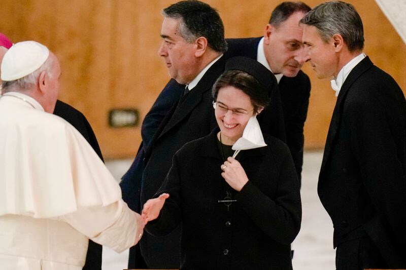 FILE - Pope Francis shakes hands with Sister Raffaella Petrini, secretary general of the Vatican's governorship, at the Vatican, on Dec. 23, 2021. (AP Photo/Alessandra Tarantino, File)