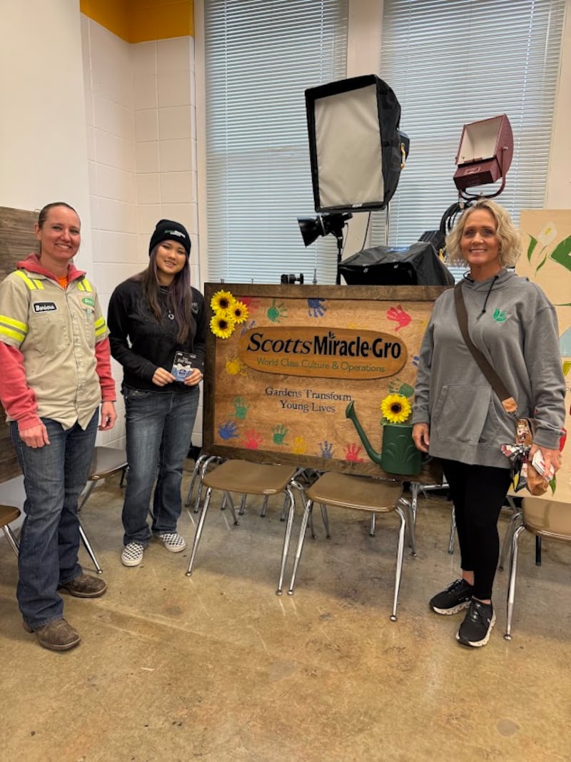 A design created by Emma Rumley (center) was selected for signage at Scotts Miracle-Gro in Morrison. She is pictured with Barbara Zigler (left) and Jennifer Kessler.
