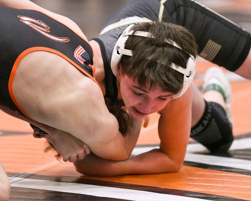 Chase Cook of Sycamore tries to keep a hold of Michael Scott of Lincoln-Way West in the 106-weight class on Monday Dec. 29, 2025, during the Flavin Invite held at DeKalb High School.