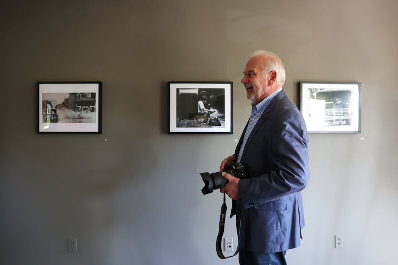 Bill "BJ" Jurevich, a longtime Daily Journal photographer, smiles as he shows family the images from his life’s work in a gallery titled, Life Through the Lens: A Photographic Retrospective, which runs through Oct. 25 at the Victorian House Gallery, 577 S. Main Street in Bourbonnais.
