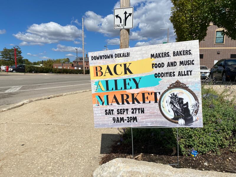 A sign for the fall season DeKalb Back Alley Market sits along First Street in downtown DeKalb on Thursday, Sept. 25, 2025. The market runs 9 a.m. to 3 p.m. downtown on Saturday, Sept. 27, at Palmer Court and Second Street.
