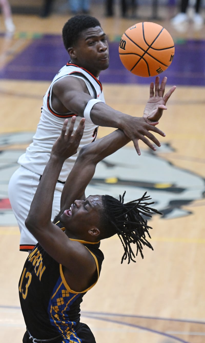Warren's Javerion Banks, front, draws contact from DeKalb's Davon Grant on his way to the basket during the Class 4A Waukegan sectional semifinal on Tuesday, March 4, 2025 in Waukegan.
