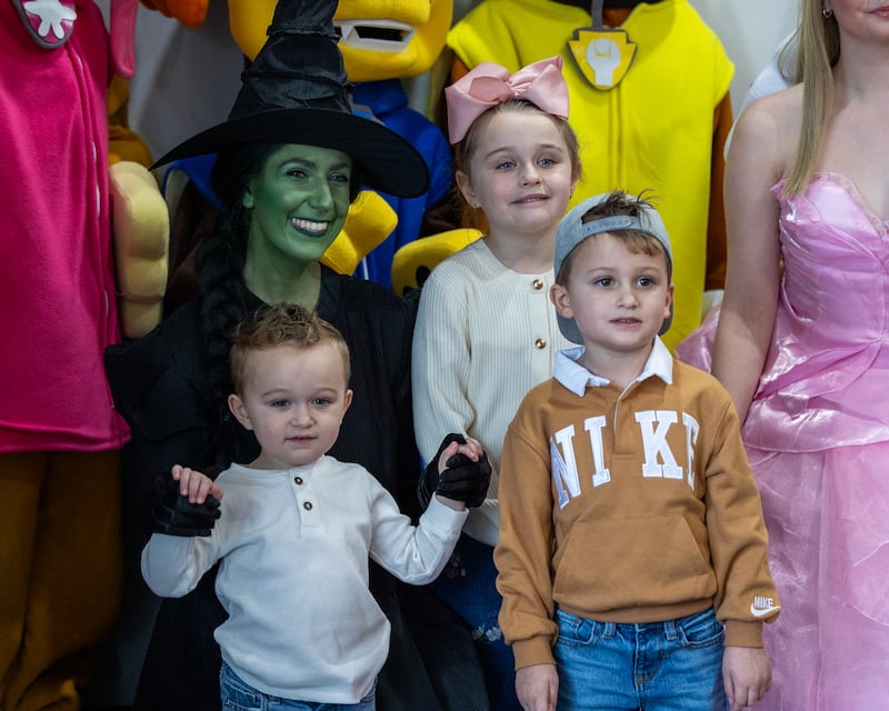 'Elphaba' (portrayed by Serena Rogers) poses for photo with kids after performance of "New Year, New Friends" on Saturday, December 27, 2025 at Stage 212 in LaSalle.