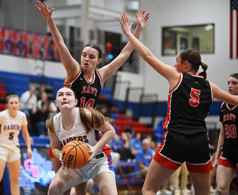 Glenbard South's Olivia Cernauske, front, tries to shoot from down low as Glenbard East's Teagan Murphy, left, and Nora Opila defend during Friday’s game in Glen Ellyn.