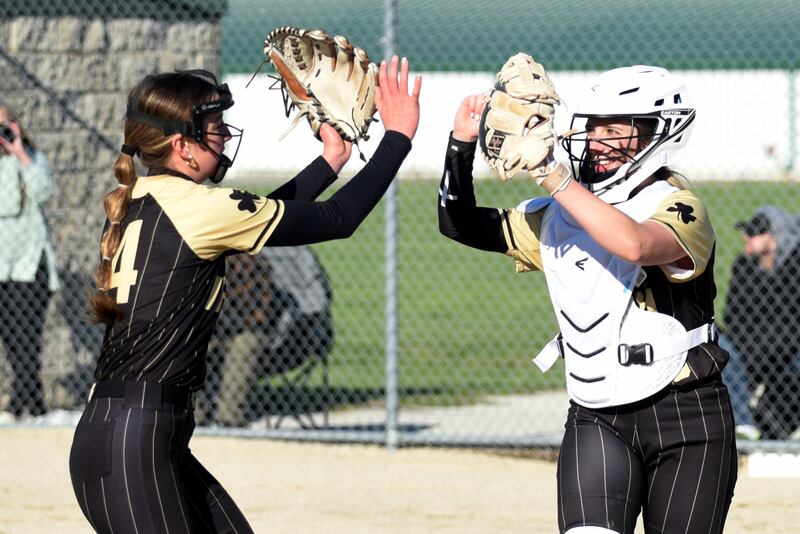 Bishop McNamara's Bridget Bertrand, right, celebrates with pitcher Joslynn Dole during Dole's shutout performance during a 15-0 victory Tuesday, April 8 at Bishop McNamara.