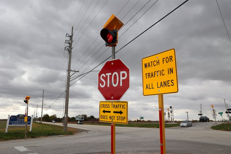 Traffic travels along IL Route 50 as vehicles approach traveling east on County Line Road on Tuesday, Oct. 21, 2025. Crews were at work that day preparing for a traffic pattern change, creating a four-way stop, at the accident-prone intersection where 18 accidents and four fatalities have occurred this year.