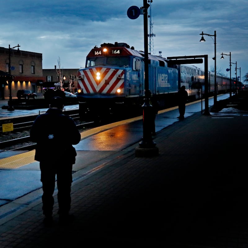 People wait for the Metra train to arrive from Chicago on Tuesday, Feb. 14, 2023, at the Crystal Lake Metra station in downtown Crystal Lake.