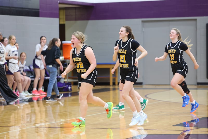 Reed-Custer's Harlie Liebermann yells in celebration alongside teammates Alyssa Wollenzien, center, and Morgan Toler, right, as the Comets secured a 45-42 upset victory over Manteno on Monday, Feb. 2, 2026.