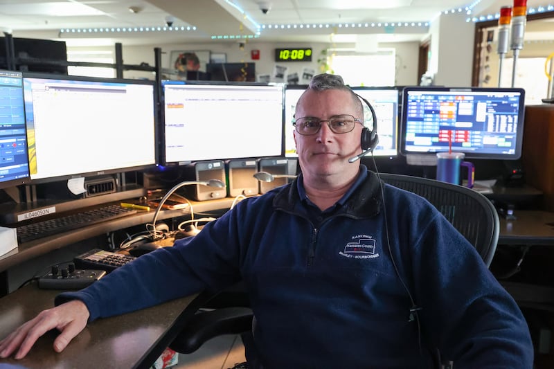 Marc Cote, a KanComm telecommunicator since 2005, sits as his station at the Kankakee dispatch headquarters on April 22, 2026.