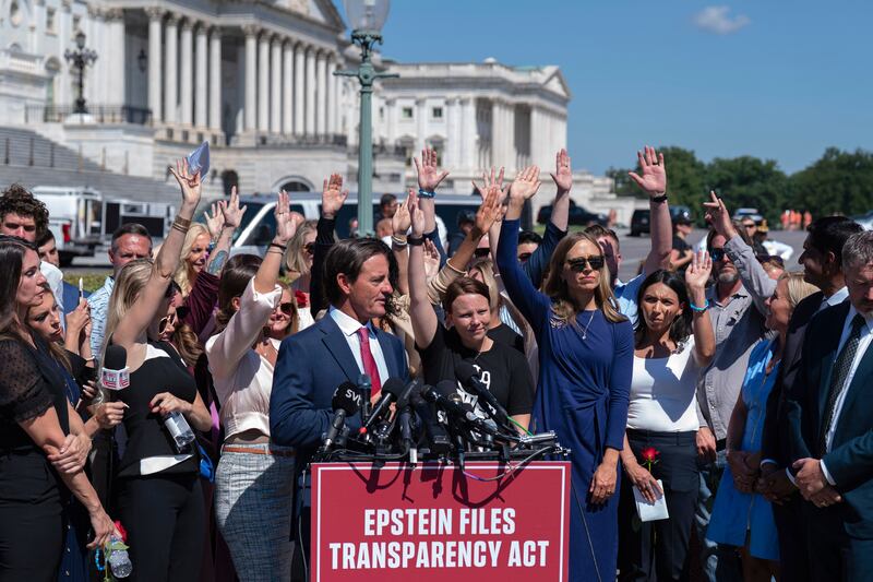Attendees raise their hands to press congress to release the Jeffrey Epstein files during a news conference at the U.S. Capitol, Wednesday, Sept. 3, 2025, in Washington. (AP Photo/Jose Luis Magana)