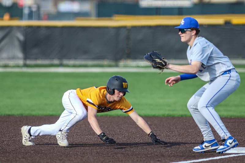 Joliet West's Daniel Markun (17) dives back to first on a pitck off attempt during baseball game between Joliet Central at Joliet West, Tuesday April 22, 2025 in Joliet.