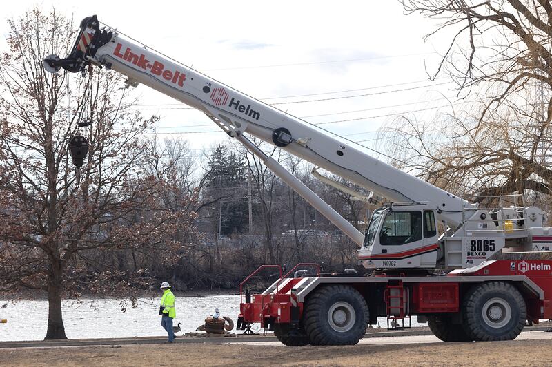 Equipment and manpower work on the north side of the river Friday, Feb. 28, 2025, in Dixon.