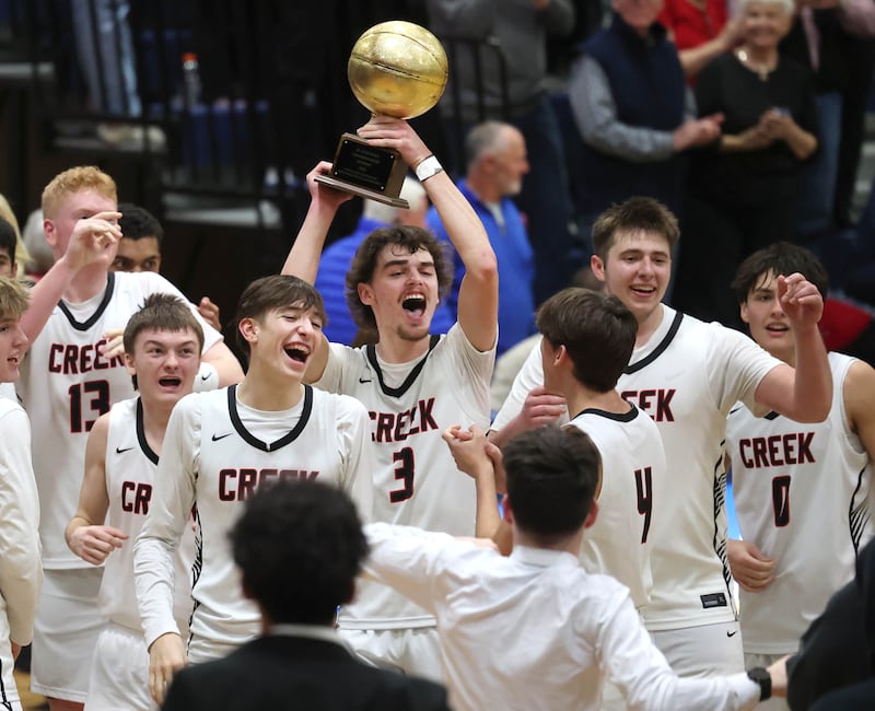 Indian Creek players celebrate winning the Little 10 Conference championship Friday, Feb. 6, 2026, after defeating IMSA at Somonauk High School.