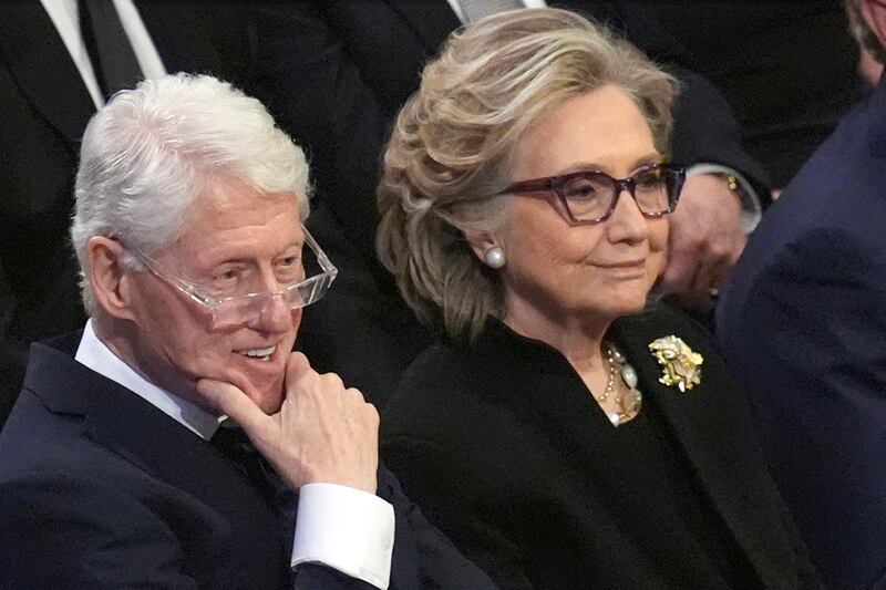 FILE - Former President Bill Clinton and former Secretary of State Hillary Clinton listen during the state funeral for former President Jimmy Carter at Washington National Cathedral in Washington, Jan. 9, 2025. (AP Photo/Jacquelyn Martin, File)