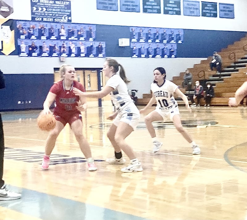 Bureau Valley's Ashlynn Maupin and Maddie Wetzell (10) defend for the Storm against Morrison in Saturday's regional quarterfinal. The Storm won 51-11.