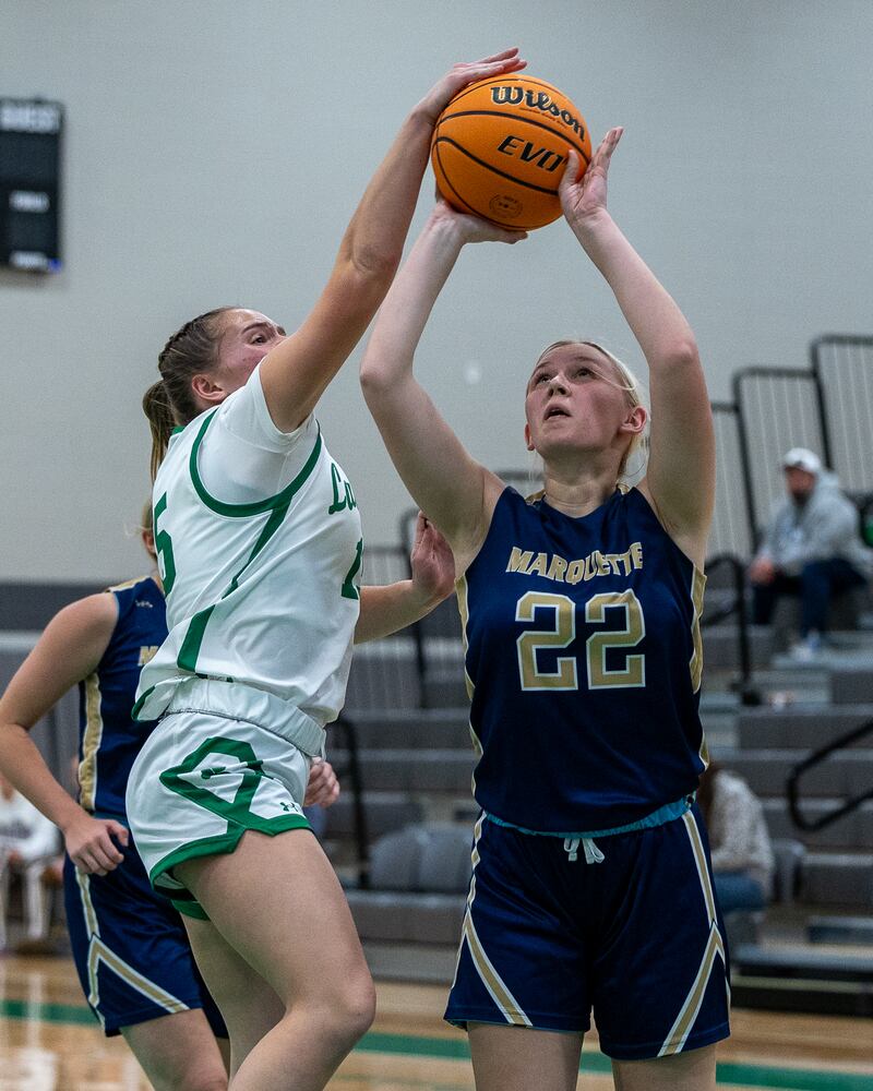Seneca's Kylee Rowley (15) blocks a shot attempt by Marquette's Navaeh Corcoran (22) on Monday, Nov. 17, 2025, during the opening night of the Falcon-Irish Thanksgiving Tournament at Seneca.