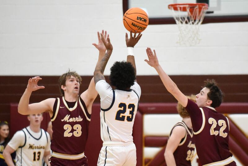 Morris' Jack Wheeler, left, and Brett Bounds, right, try to block a shot from Sterling's Kaedon Phillips during the IHSA Class 3A Morris Regional semifinals Wednesday, Feb. 26, 2025.