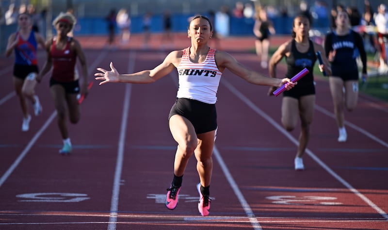 St. Charles East’s Madeline Piekarz crosses the finish line as the Saints win the 400-meter relay during the Class 3A Hoffman Estates girls track and field sectional on Thursday, May 14, 2026 in Hoffman Estates.