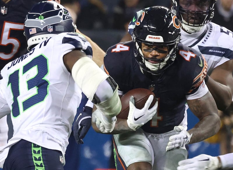 Chicago Bears running back D'Andre Swift looks to split two Seattle Seahawks defenders during their game Sunday, Dec. 26, 2024, at Soldier Field in Chicago.