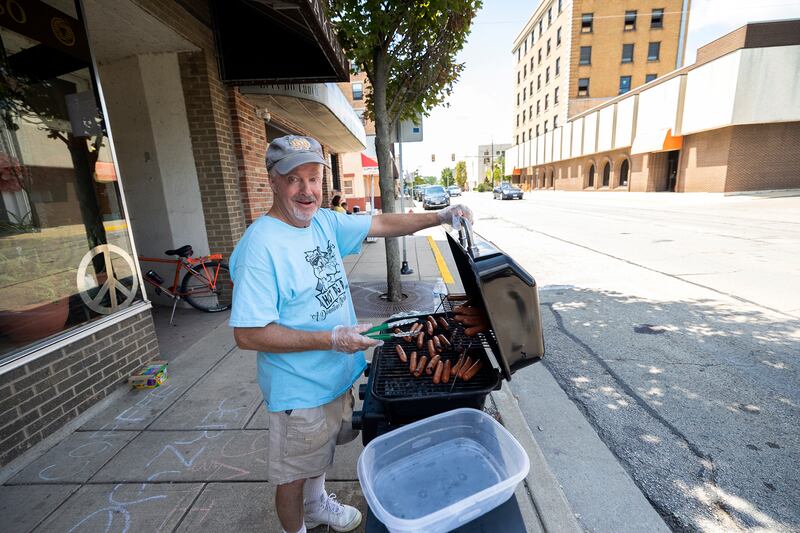 Chris Olds mans the grill outside of Air Play in Sterling on Friday, Aug. 2, 2024, for Sterling’s annual Hot Dog Day.