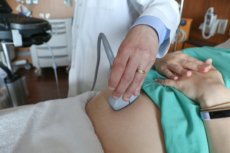 FILE - A doctor performs an ultrasound scan on a pregnant woman at a hospital in Chicago, Aug. 7, 2018. (AP Photo/Teresa Crawford, File)