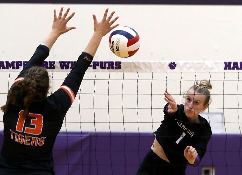 Hampshire's Elizabeth King (right) tries to hit the ball past the block attempt of Crystal Lake Central's Siena Smiejek during a Fox Valley Conference volleyball match on Tuesday, Sept. 24, 2024, at Hampshire High School.