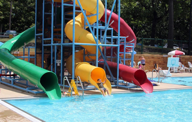 A young patron comes off one of Morris City Pool's three water slides. The pool has seen record attendance this summer.