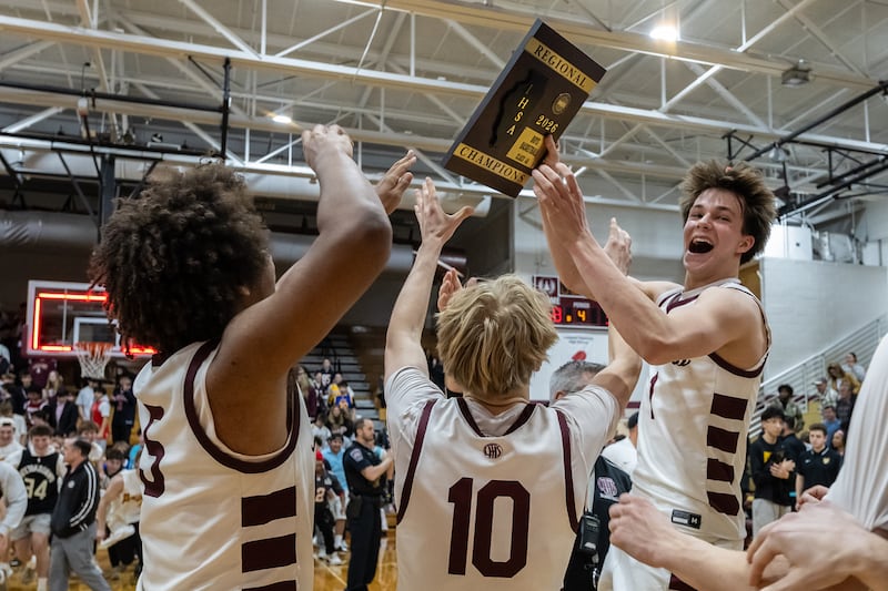 Lockport’s boys varsity basketball team celebrates after winning the IHSA 4A regional championship against Joliet West at Lockport Township High School East Campus on Feb. 27, 2026.